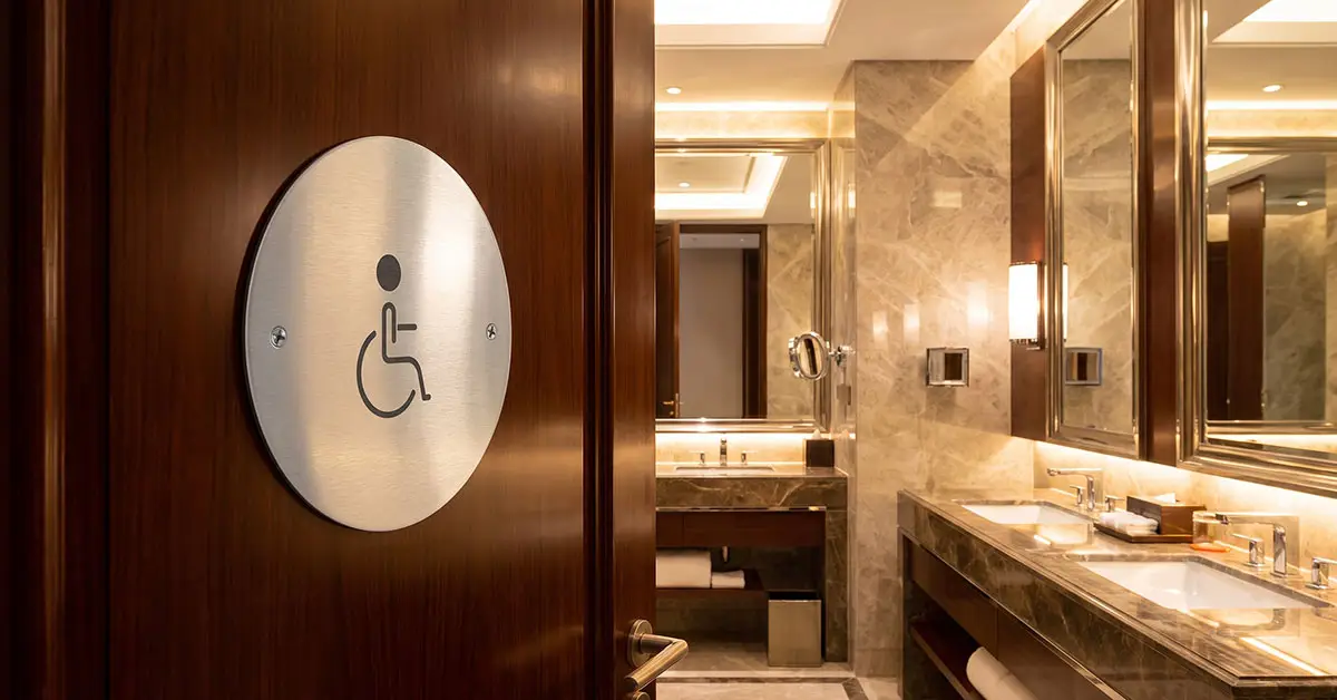 Compliant toilet sign disabled layout featuring 110mm wheelchair symbol with high-contrast matte black finish on brushed aluminium